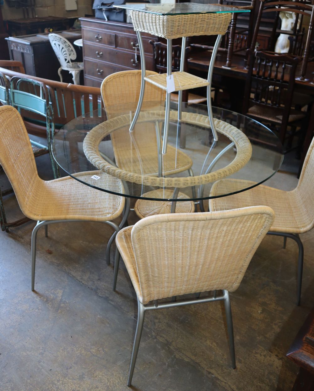 A circular glass top conservatory table, diameter 106cm, four chairs and a matching side table